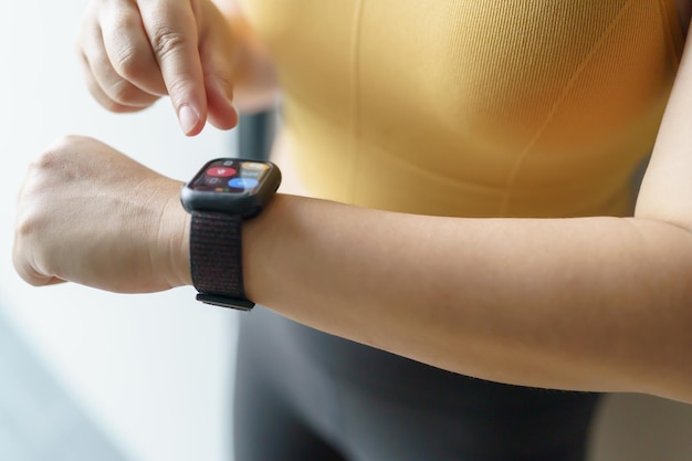 Woman workout with health app on smart watch Closeup hands