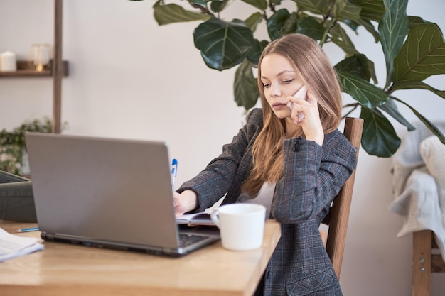 woman works at home or in a business incubator freelancing concept relaxed in the workplace