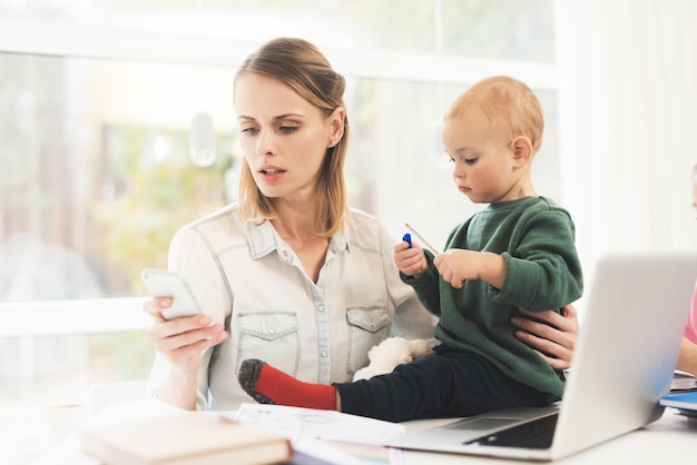 A woman works during maternity leave at home 