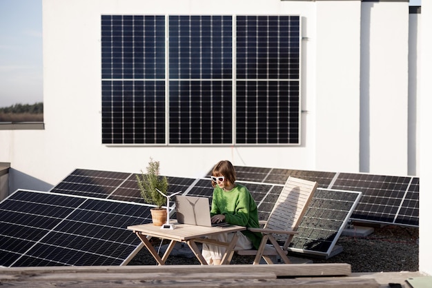 Woman works on a rooftop with a solar power plant