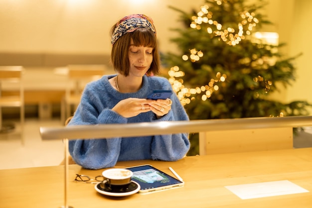 Woman works on touchpad at coffee shop