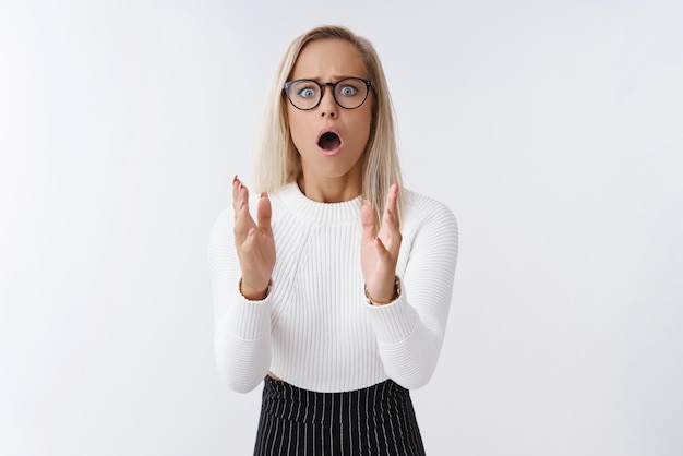 Woman worrying drunk friend drop fragile vase standing in stupor raising palms frowning and open mouth from shook and nervousness