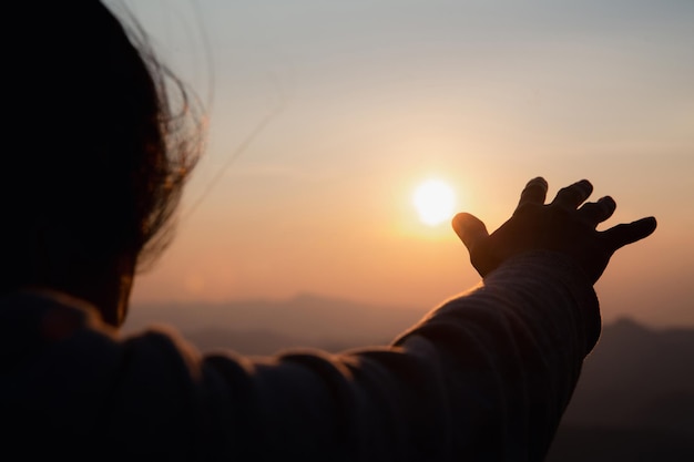 Woman worship on sunset