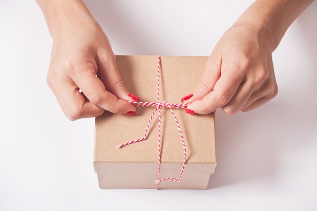 Woman wrapping gift box.