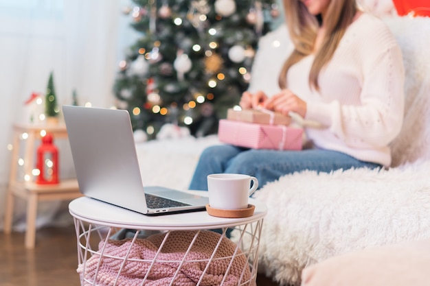 Woman wrapping up Christmas gifts for family