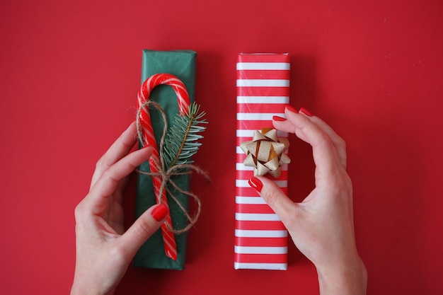 woman wraps presents for the holidays