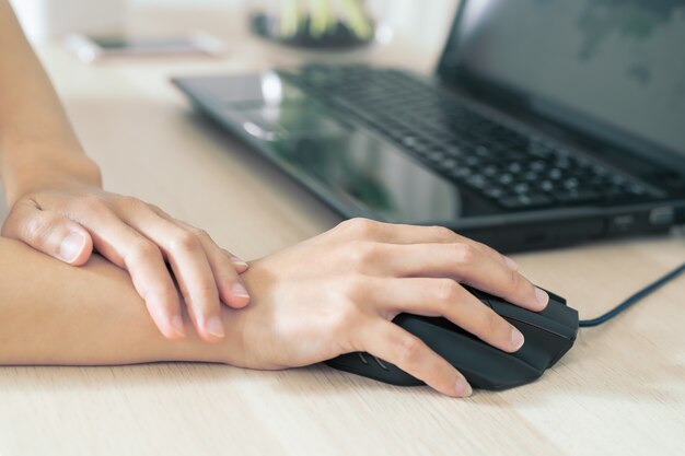 Woman wrist arm pain long use mouse working. office syndrome healthcare.