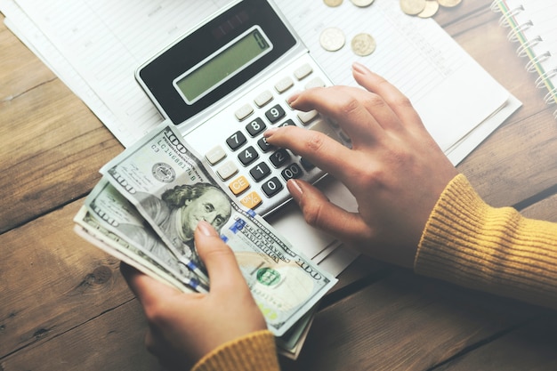 Woman write and money on table