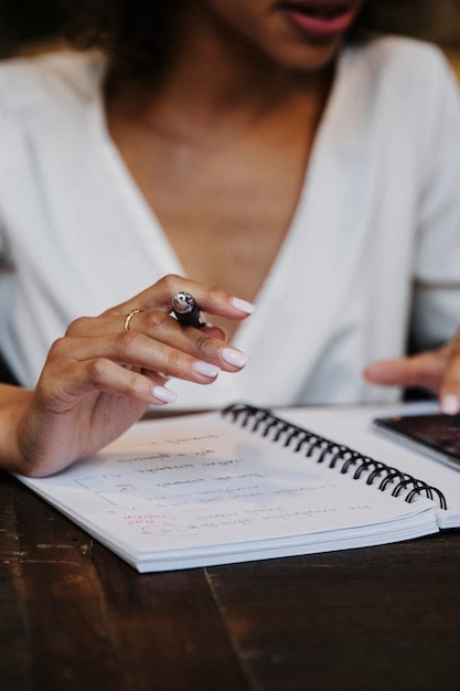 Woman writing down on her notebook