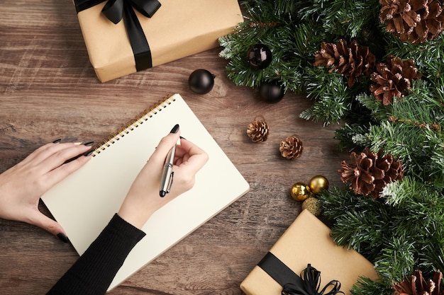 Woman Writing List on Notepad