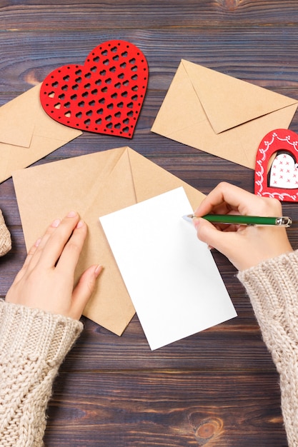 Woman writing love letter or romantic poem for Valentines day