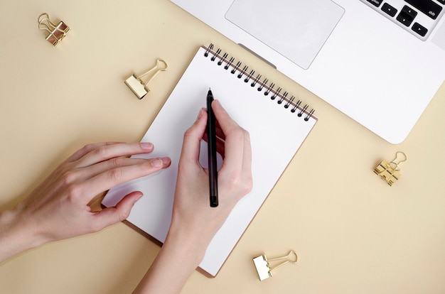 Woman writing on notebook