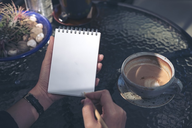 Woman writing on notebook