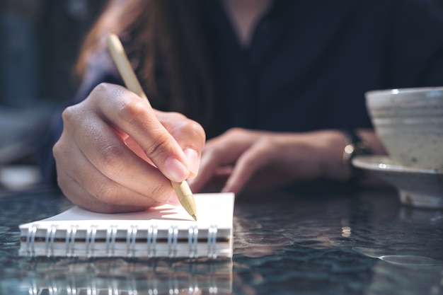 Woman writing on notebook