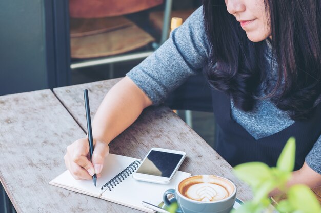 Woman writing on a notebook