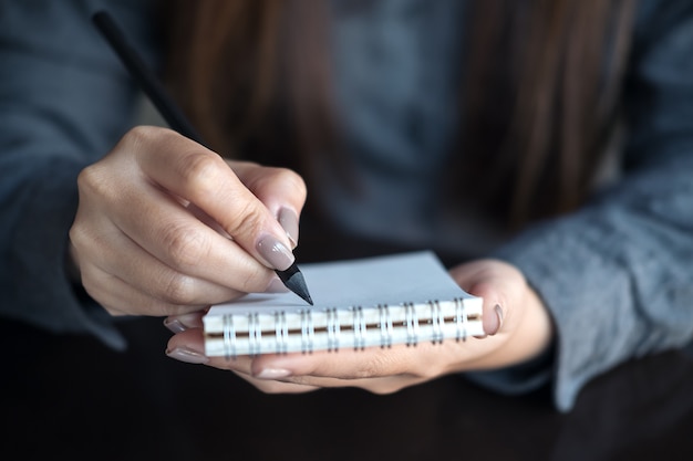 Woman writing on notebook