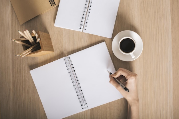 Woman writing in notepad top