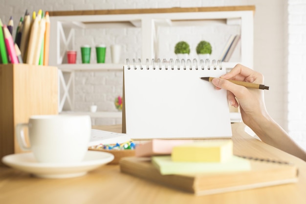 Woman writing in notepad