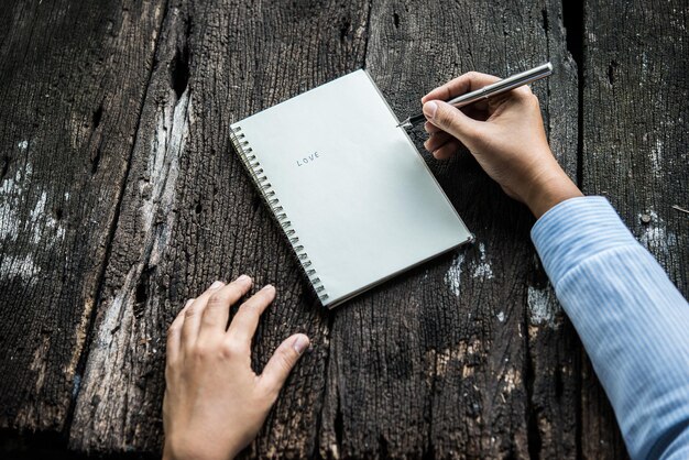 Photo woman writing something on notebook