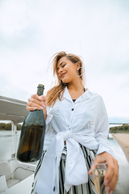 Woman on a yacht drinking champagne