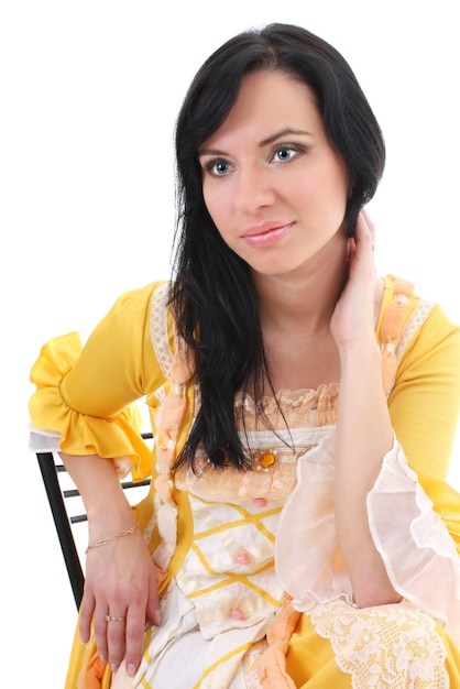 Woman in yellow medieval dress over white background