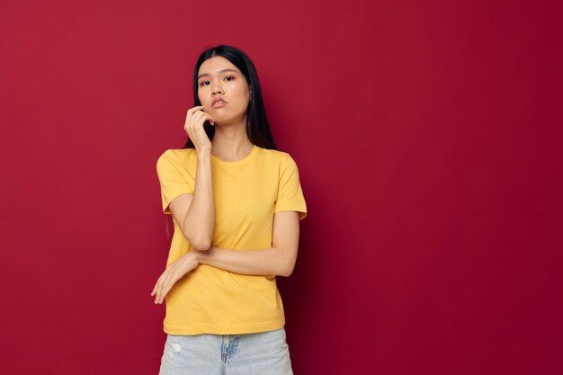 woman in a yellow t-shirt gesturing with his hands fun isolated background unaltered. High quality photo