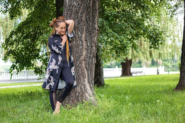 Woman yogi with dreadlocks practicing pose of yoga