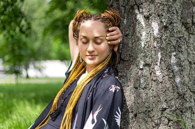 Photo woman yogi with dreadlocks practicing siddhasana ardha padmasana lotus pose of yoga