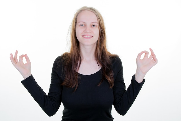 Woman young beauty on white background in yoga with finger okay gesture and casual clothes