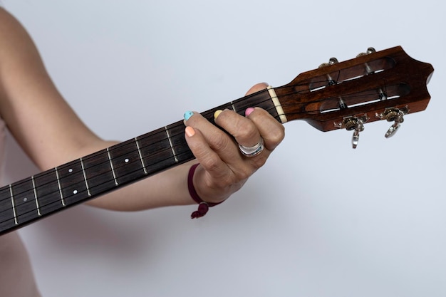 Woman39s hands playing a major chord on a cuatro Venezuelan folk instrument