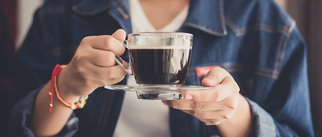 ホットコーヒーのカップを保持しているWomand