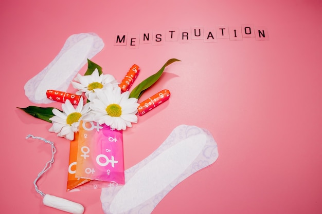 womans comfort and hygienic protection, menstruation, sanitary pads on pink background.space