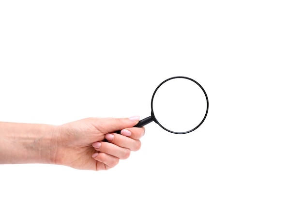 womans hand holding magnifying glass