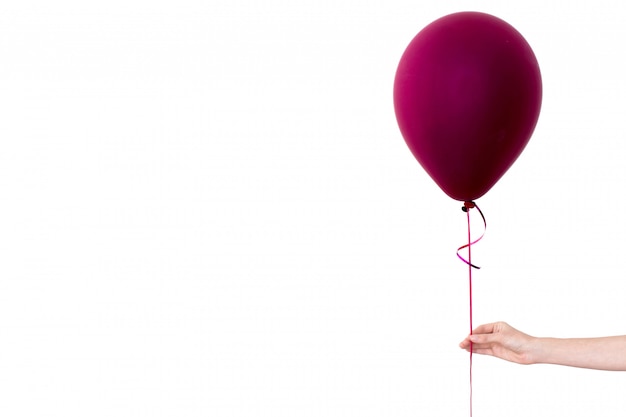 Womans hand holds purple balloon white background