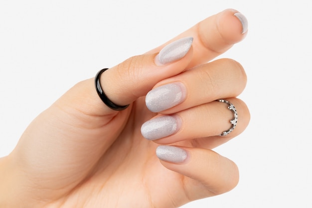 Womans hand with grown manicure on white background