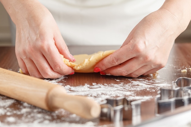 Womans hands making home made biscuits close up