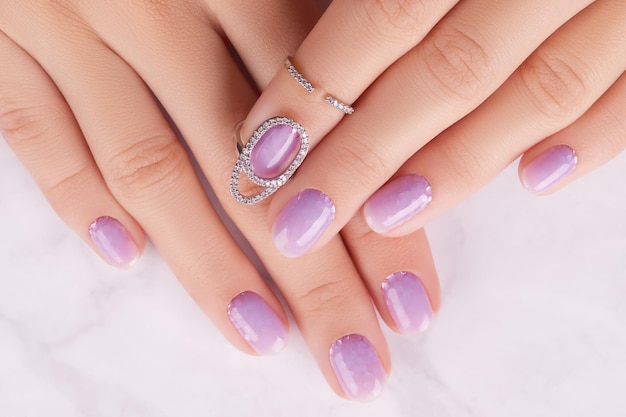 Womans hands with trendy lavender manicure Spring summer nail design