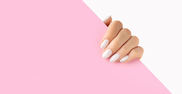 Womans hands with trendy white french manicure