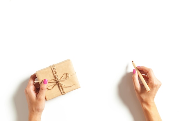 Womans hands wrapping a gift