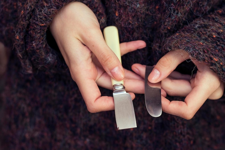 Photo womans holding a broken butter knifebroken kitchen knife blade