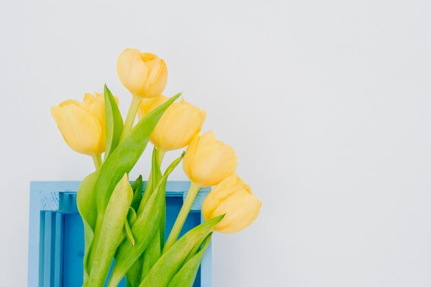 Womans holiday yellow Spring tulips  blue wooden cart box