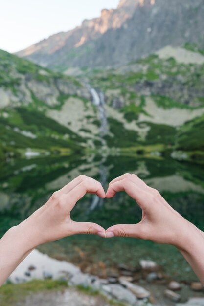 Womans making heart shape with her hands