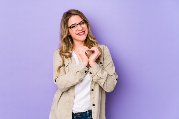 Womansmiling and showing a heart shape with hands