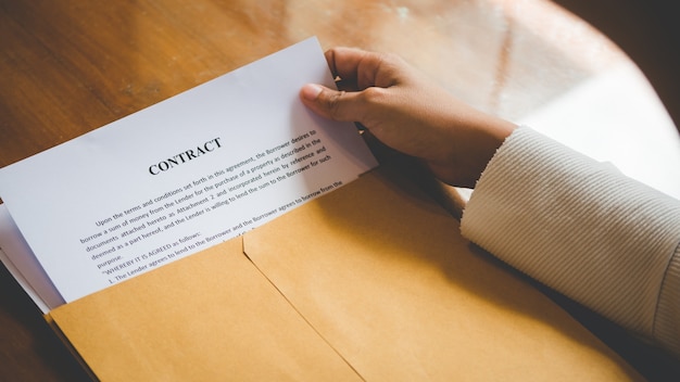 Women are opening an envelope document about signing a contract in business 