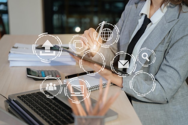 Women are using tablet to work at the desk in the morning