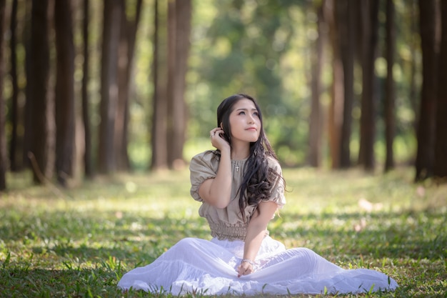 Women asian girl sitting relaxing in the pine forest nature 