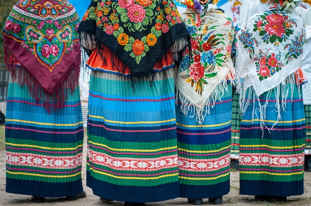 Women in belarusian folk costumes embroidered dresses and\
painted scarves traditional autumn harvest festival people and\
traditions