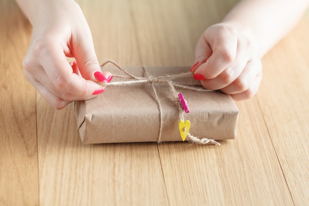 Women binds classic bow for gift