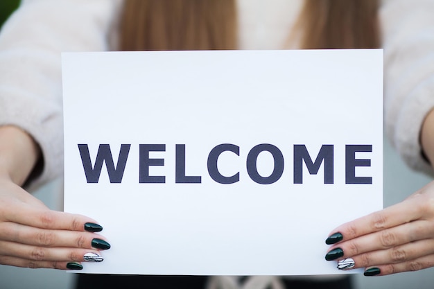 Women business with the poster with welcome message