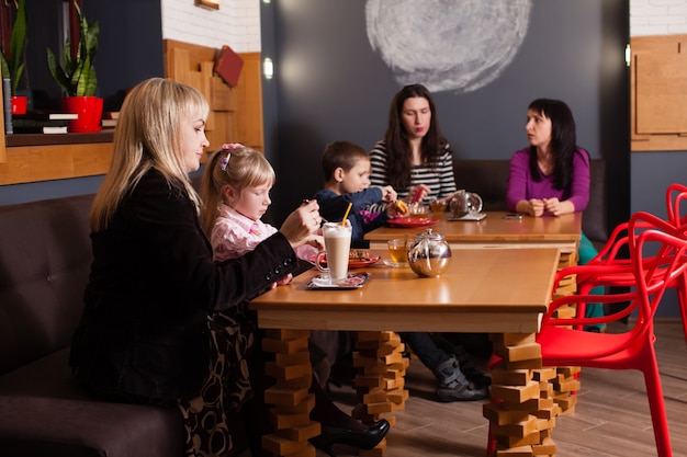 Women and children having a drink